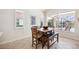Cozy dining area features a wooden table, bench, and scenic views of the pool at 133 Treviso Ct, North Venice, FL 34275