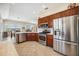 Modern kitchen with stainless steel appliances, granite countertops, and ample cabinet space at 133 Treviso Ct, North Venice, FL 34275