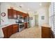 Well-lit kitchen features stainless steel appliances, granite countertops, tile backsplash, and wood cabinets at 133 Treviso Ct, North Venice, FL 34275