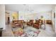 Spacious living room featuring leather furniture, a ceiling fan, and a colorful rug on tile flooring at 133 Treviso Ct, North Venice, FL 34275