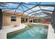 Inviting screened-in pool and patio area with lounge chairs, hot tub and tile flooring at 133 Treviso Ct, North Venice, FL 34275