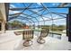 Inviting screened-in pool with a spa and a lake view features two lounge chairs for relaxation at 133 Treviso Ct, North Venice, FL 34275