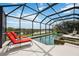 Relax by the screened-in pool and spa with gorgeous lake views in the backyard at 133 Treviso Ct, North Venice, FL 34275