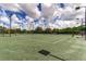 Well-maintained tennis courts for recreational enjoyment with lighting for evening play and lush tree background at 133 Treviso Ct, North Venice, FL 34275