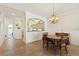Traditional dining room featuring chandelier lighting and views of the kitchen, perfect for Gathering meals and entertaining at 1537 Monarch Dr, Venice, FL 34293