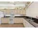 Bright kitchen featuring granite countertops, modern appliances, and ample cabinet space, ideal for cooking and entertaining at 1537 Monarch Dr, Venice, FL 34293