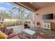 Screened patio featuring outdoor seating, BBQ grill, and views of the well-maintained backyard, perfect for outdoor relaxation at 1537 Monarch Dr, Venice, FL 34293