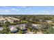 A beautiful view of homes on the water, surrounded by lush tropical landscape and blue skies, offering serene waterfront living at 174 Southampton S Pl # 345, Venice, FL 34293