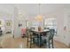 A cozy dining area features a chandelier, a wooden table with chairs, and natural light from the window at 174 Southampton S Pl # 345, Venice, FL 34293