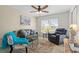 Comfortable living room with neutral colors, a plush sofa, and a charming accent chair at 174 Southampton S Pl # 345, Venice, FL 34293