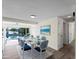 Bright dining room featuring a white table, chairs with patterned cushions, and a view of the pool at 18053 Cullman Ave, Port Charlotte, FL 33948