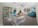 Inviting home office with a large desk, built-in bookcase, and comfortable blue armchairs at 18053 Cullman Ave, Port Charlotte, FL 33948