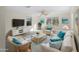 Bright living room offering comfortable seating, a glass coffee table, and calming beach-themed artwork at 18053 Cullman Ave, Port Charlotte, FL 33948