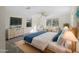 Serene main bedroom with a wooden bed frame, cozy blue accents, and tranquil natural light at 18053 Cullman Ave, Port Charlotte, FL 33948