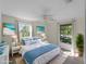 Relaxing main bedroom with a comfortable bed, beachy decor, and bright natural light from the windows at 18053 Cullman Ave, Port Charlotte, FL 33948