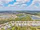 Beautiful aerial view of a neighborhood featuring tree lined streets and well-maintained homes near a lake at 19832 Bridgetown Loop, Venice, FL 34293