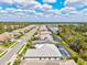Aerial view showcasing a serene residential neighborhood with stunning lake views at 19832 Bridgetown Loop, Venice, FL 34293