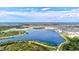 Stunning aerial view of the lake and green spaces, showcasing outdoor trails for walking and biking at 19832 Bridgetown Loop, Venice, FL 34293