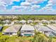 Wide aerial shot showing a peaceful neighborhood surrounded by lush green trees and landscaping at 19832 Bridgetown Loop, Venice, FL 34293