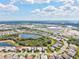 Breathtaking aerial view of a community surrounded by pristine lakes, lush green forest and commercial property at 19832 Bridgetown Loop, Venice, FL 34293