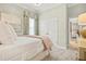 Cozy bedroom featuring plush carpet, closet, and a window with decorative valance and curtains at 19832 Bridgetown Loop, Venice, FL 34293