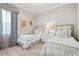 Bedroom showcasing two twin beds with patterned pillows and a window providing natural light at 19832 Bridgetown Loop, Venice, FL 34293