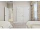 Bedroom featuring two twin beds, an open doorway, and a closet with double doors at 19832 Bridgetown Loop, Venice, FL 34293