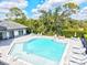 Relax and unwind by the community pool, surrounded by lush landscaping and comfortable seating at 19832 Bridgetown Loop, Venice, FL 34293