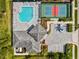 Aerial shot of the community pool and tennis courts provides residents a place for outdoor recreation at 19832 Bridgetown Loop, Venice, FL 34293