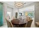 Open-concept dining room with modern lighting and views to the living space at 19832 Bridgetown Loop, Venice, FL 34293