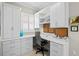 Bright home office with custom cabinets, drawers, shelving, and a comfortable office chair at 19832 Bridgetown Loop, Venice, FL 34293