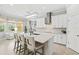 Bright, open kitchen with a large center island, quartz countertops, and modern lighting at 19832 Bridgetown Loop, Venice, FL 34293