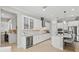 Open kitchen with a wine cooler, white cabinetry, and stainless steel appliances at 19832 Bridgetown Loop, Venice, FL 34293