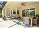 Covered outdoor patio with comfortable seating and dining area, perfect for relaxation and entertainment at 19832 Bridgetown Loop, Venice, FL 34293