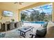 Covered lanai featuring dining and seating areas overlooking a private pool and landscaped backyard at 19832 Bridgetown Loop, Venice, FL 34293