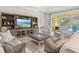 Spacious living room with comfortable seating and access to the screened pool at 19832 Bridgetown Loop, Venice, FL 34293