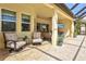 Covered patio boasts comfortable seating, a TV, and seamless indoor-outdoor living at 19832 Bridgetown Loop, Venice, FL 34293