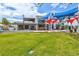 Expansive green lawn in a town center, near eateries and stores, with a clear blue sky overhead at 19832 Bridgetown Loop, Venice, FL 34293