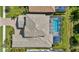 Aerial view of property showcasing pool, tile roof, surrounding greenery, and lush landscaping at 19836 Bridgetown Loop, Venice, FL 34293