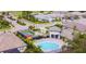 Community aerial view featuring a pool, tennis court, gatehouse, and lush landscaping at 19836 Bridgetown Loop, Venice, FL 34293