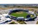 Aerial view of a baseball stadium with a perfectly manicured field and extensive seating surrounded by lush greenery at 19836 Bridgetown Loop, Venice, FL 34293