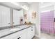 Bathroom featuring a granite countertop vanity, a sink, and a mirror with decorative elements at 19836 Bridgetown Loop, Venice, FL 34293