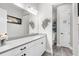 Modern bathroom featuring a white vanity with gray countertop, a large mirror, and stylish decor at 19836 Bridgetown Loop, Venice, FL 34293