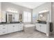 Luxury bathroom with dual vanities, soaking tub, and modern fixtures at 19836 Bridgetown Loop, Venice, FL 34293