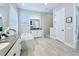 Bright bathroom featuring a soaking tub, dual vanities, and tiled walk-in shower at 19836 Bridgetown Loop, Venice, FL 34293