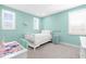 Light and airy bedroom featuring blue walls, white furniture, and ample natural light from multiple windows at 19836 Bridgetown Loop, Venice, FL 34293