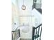 Elegant foyer featuring a staircase, decorative wall paneling, and a stylish chandelier at 19836 Bridgetown Loop, Venice, FL 34293