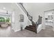 Bright foyer with hardwood floors, staircase, and an arched window providing natural light at 19836 Bridgetown Loop, Venice, FL 34293
