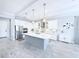 Eat-in kitchen with stainless steel appliances, pendant lighting, and a large center island at 19836 Bridgetown Loop, Venice, FL 34293