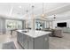 Spacious open kitchen featuring a large center island with quartz countertops and pendant lighting at 19836 Bridgetown Loop, Venice, FL 34293